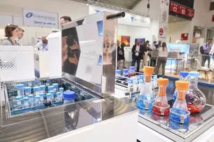 An exhibition stand with colorful pistons in the background and advertising materials.