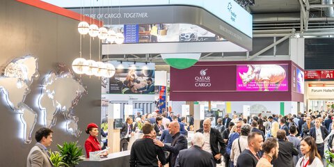 Many visitors at the Turkish Cargo stand. In the background, the Qatar Cargo stand with many trade fair visitors.