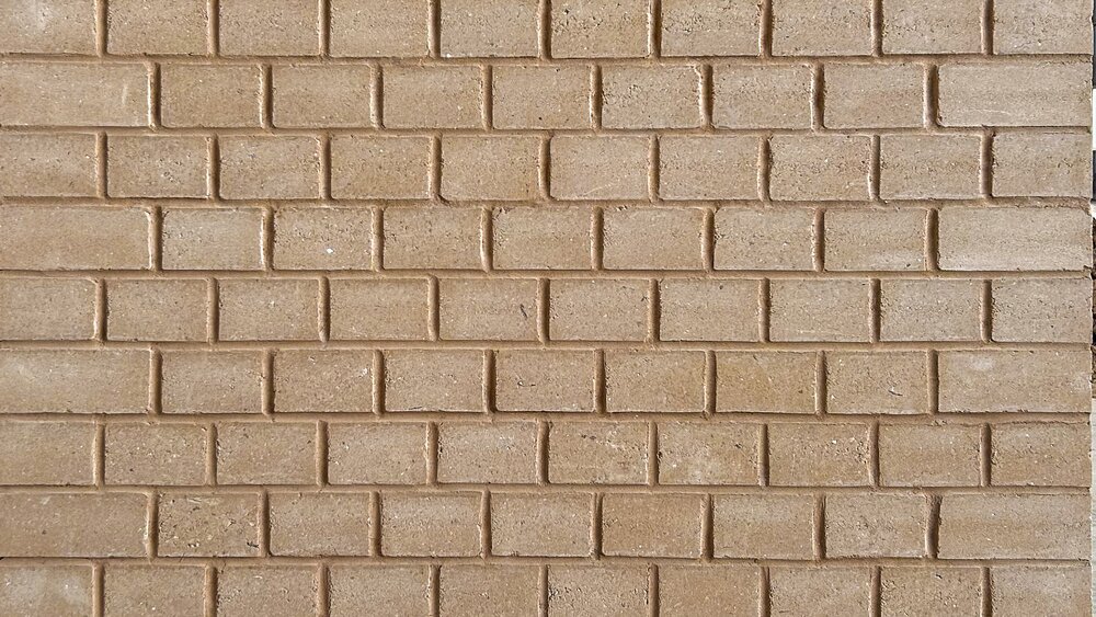 Uniform surface of small light brown bricks laid in horizontal rows, showing the texture of a wall without additional elements.