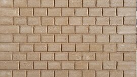 Uniform surface of small light brown bricks laid in horizontal rows, showing the texture of a wall without additional elements.