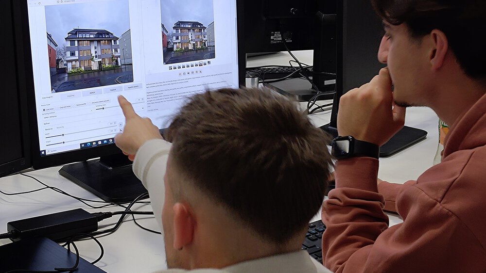 Two people at a desk look at real estate photos and details on a computer screen.