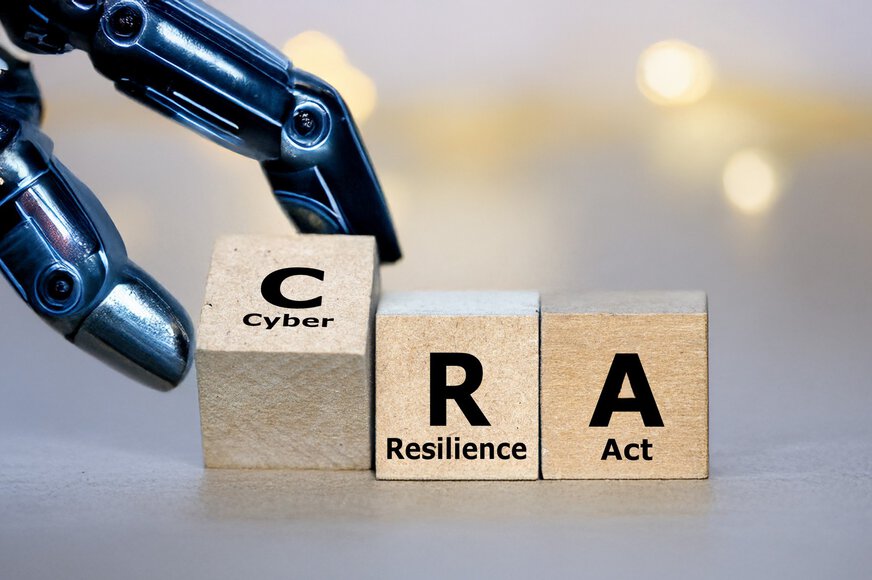 A detailed close-up of a metallic, glossy robotic hand touching three wooden blocks lined up side by side. The blocks are printed with the letters 
