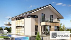 Modernes zweistöckiges Haus mit großen Fenstern und Satteldach, ausgestattet mit einem DGNB-Nachhaltigkeitszertifizierungsabzeichen.