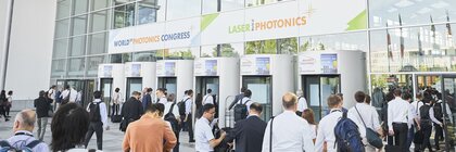 People enter the Laser World of Photonics and World of Photonics Congress building through revolving doors.