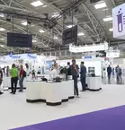 a man on the phone looks at an exhibition stand