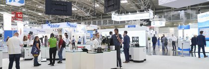 a man on the phone looks at an exhibition stand