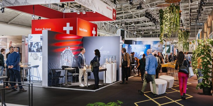 A view of a crowded exhibition hall during INHORGENTA, featuring numerous booths, promotional banners, and plant decorations.