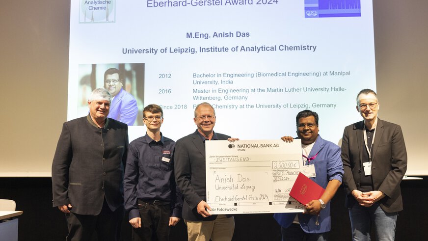Handing over a giant cheque to Anish Das on the stage of the Eberhard Gerstel Award 2024