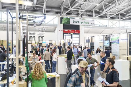 Lively activity at and around the tables in the IFAT Munich Start up Area.