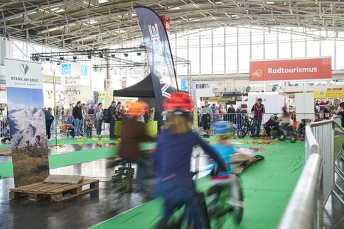 Several children test bicycles on the bicycle course area at the free fair