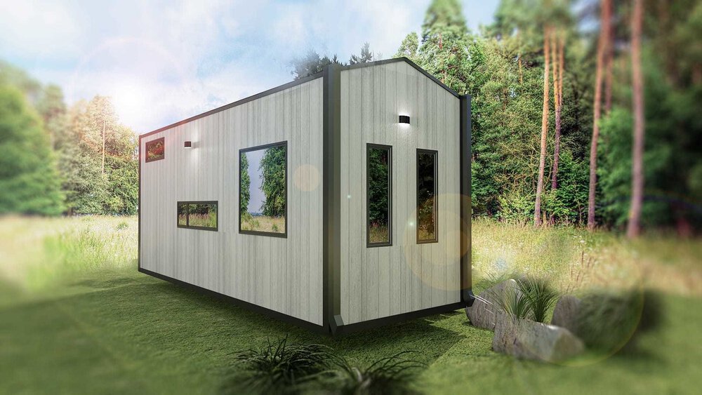 Modernes Tiny House mit großen Fenstern in einer Rasenfläche, umgeben von Bäumen.