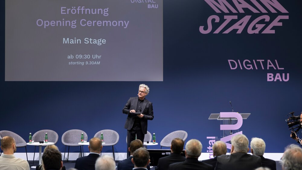 Eröffnungsveranstaltung der digitalBAU, Bühne mit digitalBAU Logo und Moderator Boris Schade-Bünsow - Chefredakteur Bauwelt, Bauverlag