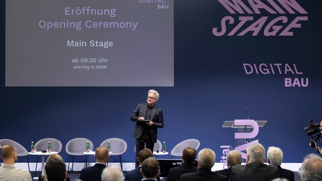 Opening ceremony of digitalBAU, stage featuring the digitalBAU logo and host Boris Schade-Bünsow—editor-in-chief of Bauwelt, Bauverlag