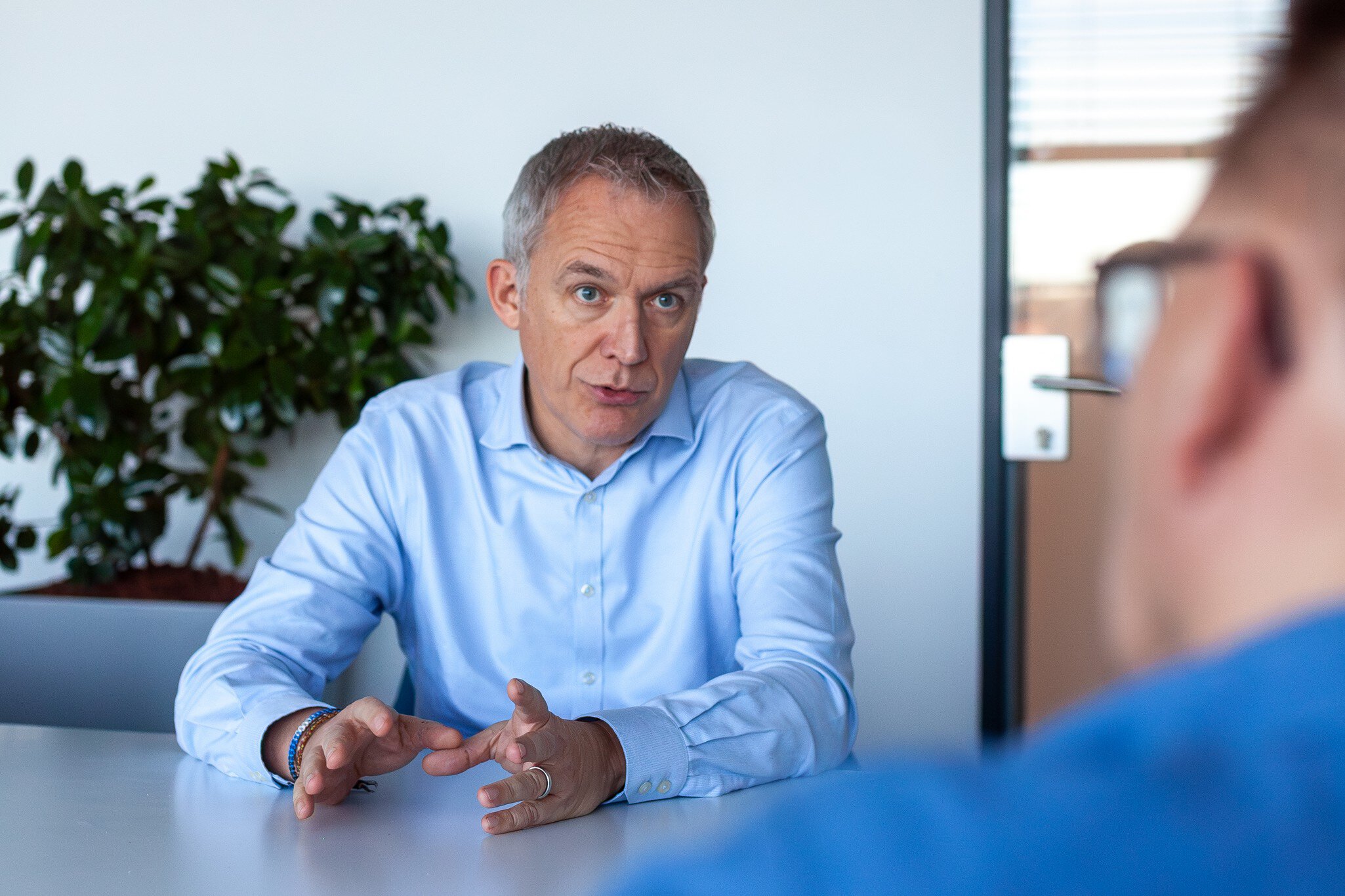 A businessman talking at a table during a meeting