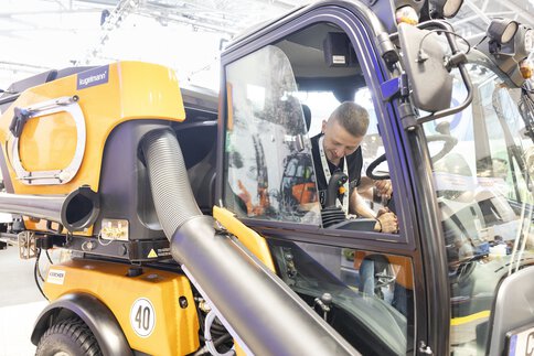 Visitor watches live demonstration of a recycling plant