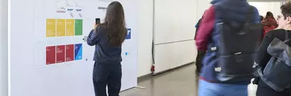 Eine Person steht vor dem Hallenplan der f.re.e, IMOT und MAT 2024 und macht ein Handyfoto
