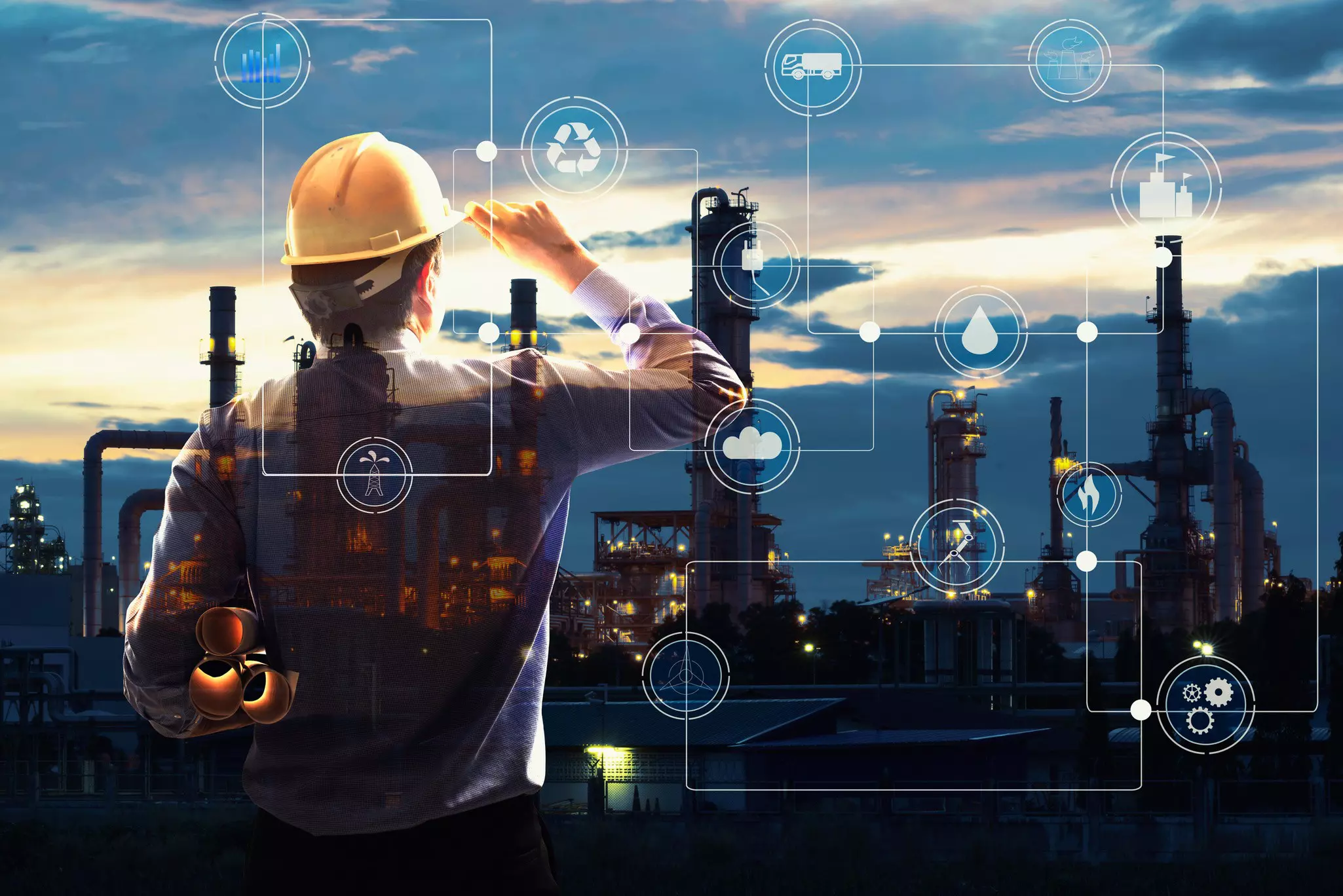 Man with construction site helmet looking at factory. Graphic elements in the picture, such as a drop for water or a flame for fire, are intended to show which factors should be taken into account during construction.