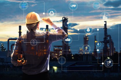 An engineer in a hard hat and waistcoat looks out over a construction site at sunrise while technical graphics are superimposed.