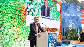 Stefan Rummel giving a speech at a lectern on the 