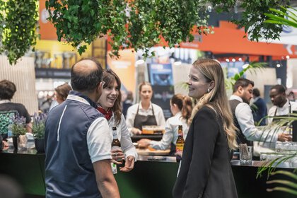Participants of the IFAT Munich Startup Night networking and exchanging ideas at an evening event. 