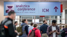 People follow a sign with an arrow pointing towards the ICM