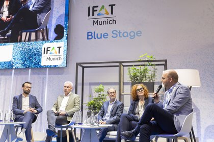 Five people sit down for a panel discussion on the Blue Stage at IFAT Munich.