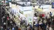 Bird's eye view of a large exhibition stand on the subject of Upper Bavaria in an exhibition hall with many visitors.