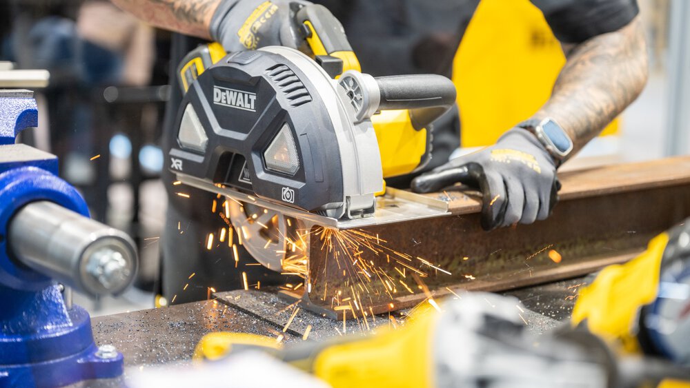 A person wearing gloves sparks saws a steel beam with a DeWalt circular saw at BAU 2025.