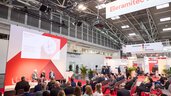 The opening of ceramitec on a stage with an audience in an exhibition hall.