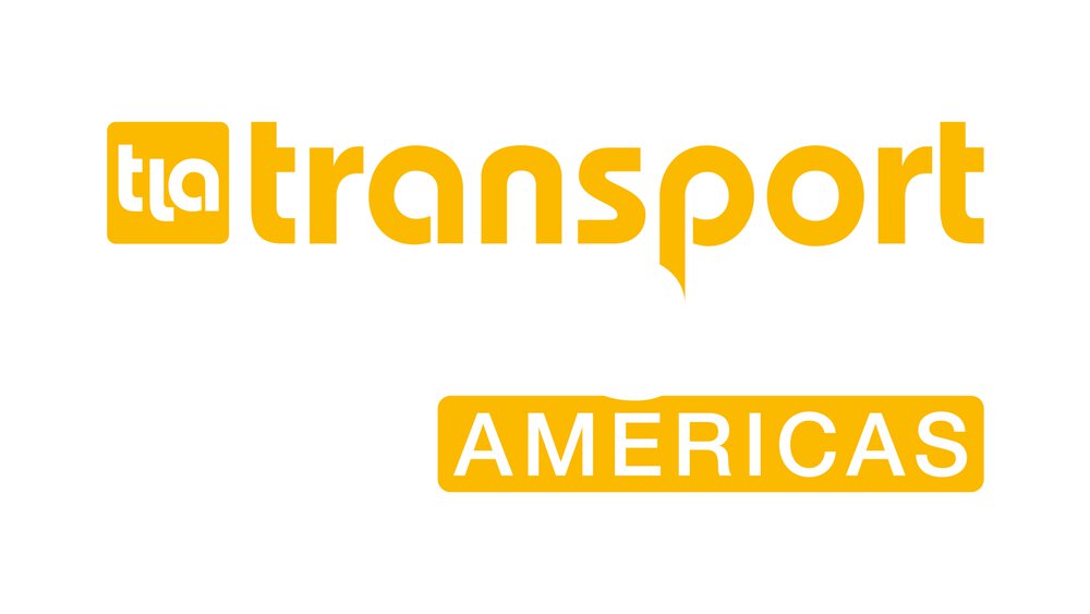 The transport logistic AMERICAS logo in yellow and white lettering with the initials “tla” in a yellow square in front of it.