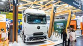 A large white Mercedes Benz truck stands in the centre of the milence stand. The truck is called eEACTROS 600 and is electric.