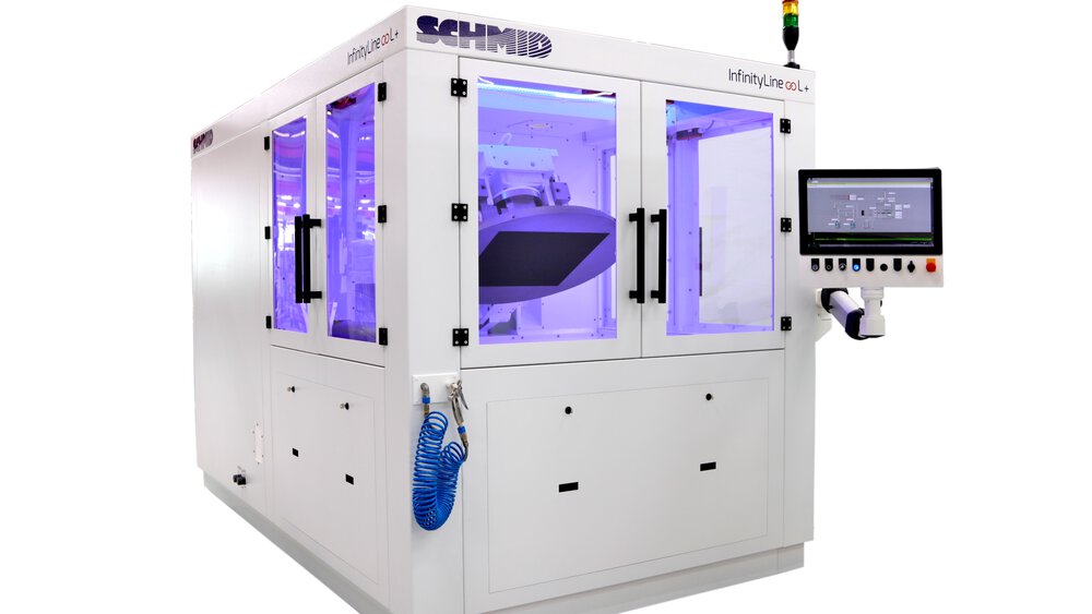 A white rectangular machine with a monitor and several windows that can be opened, with a purple light behind it.