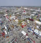 Aerial view of bauma with many stands, construction machines and cranes on the grounds of Messe München.