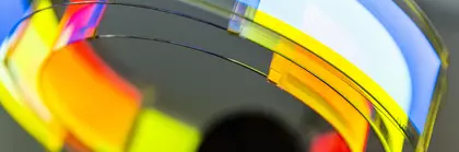 A plastic structure with a reflective, curved surface. The colors include red, yellow, blue and white