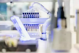 Close-up of a pipette holder with several pipettes in a modern laboratory.