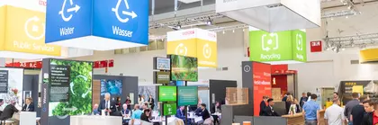 Well-attended, colorful booth with banners about the Sustainable Development Goals.
