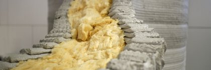 Close-up of insulation material inside a 3D-printed concrete structure.