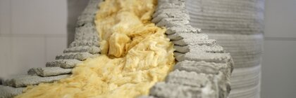 Close-up of insulation material inside a 3D-printed concrete structure.