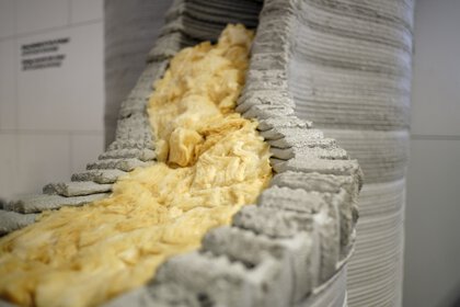 Close-up of insulation material inside a 3D-printed concrete structure.