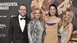 Four people in evening dress pose in front of a logo wall with the INHORGENTA AWARD trophy.