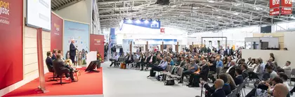 Five people on a stage in front of a large audience during transport logistic in Hall B2 of the Munich Trade Fair Centre.