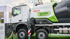 CIFA concrete mixer lorry parked on green ground in the outdoor exhibition area.