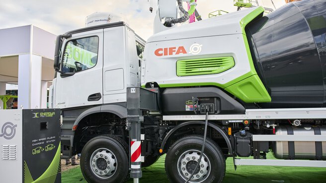 CIFA concrete mixer lorry parked on green ground in the outdoor exhibition area.
