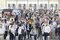 Numerous visitors stand and wait in front of the ticket controls for admission to the automatica trade fair at the Messe München exhibition centre.