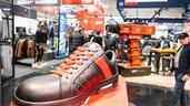 Close-up of a black and orange shoe at a trade fair stand for workwear at BAU.