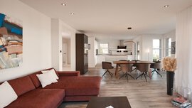 Moderner offener Wohn- und Essbereich mit rotem Sofa, großem Tisch und hellem Tageslicht.