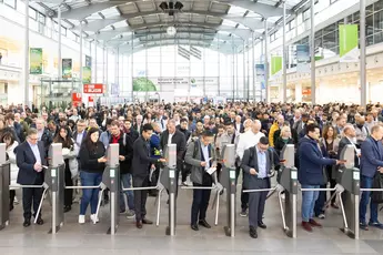 A large crowd flows through the turnstiles at the West Entrance of Messe München to electronica 2024