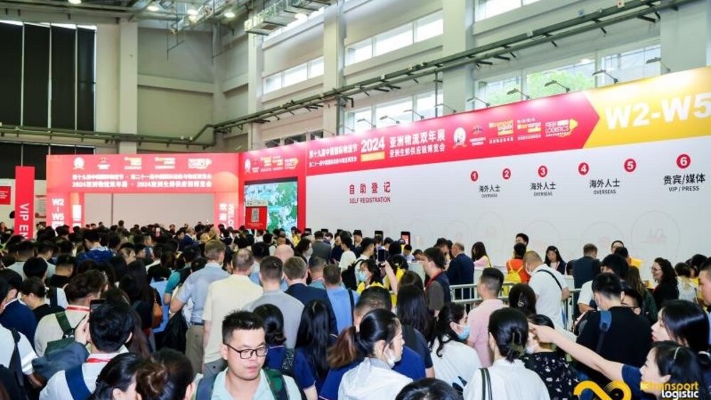 Well-attended transport logistic CHINA, with long information boards with Chinese characters on the walls.