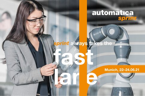 A woman wearing safety goggles interacts with a robotic arm; details of the automatic sprint event overlay the image.