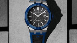 Nahaufnahme einer Armbanduhr von „Maurice Lacroix“ mit einem blau umrandeten Ziffernblatt und einem schwarzen und blauen Armband.